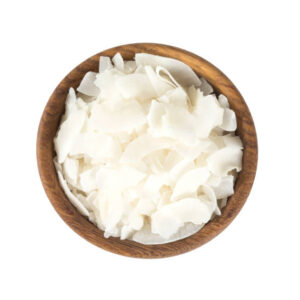 Coconut flakes in a wooden bowl isolated on white