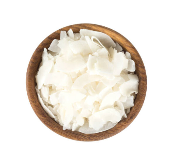 Coconut flakes in a wooden bowl isolated on white