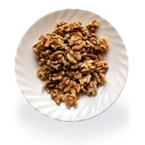 Walnuts in a white plate isolated