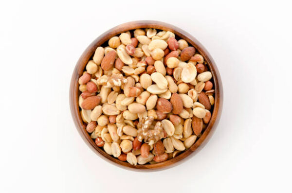 Mixed nuts in wooden bowl on white background.