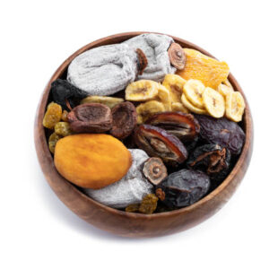 Dried fruits in wooden bowl isolated on white