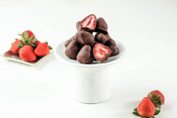Dried strawberry coating with milk chocolate. on white background
